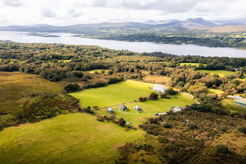 Aerial view of the sheep farm, the three cabins and Kenmare Bay behind